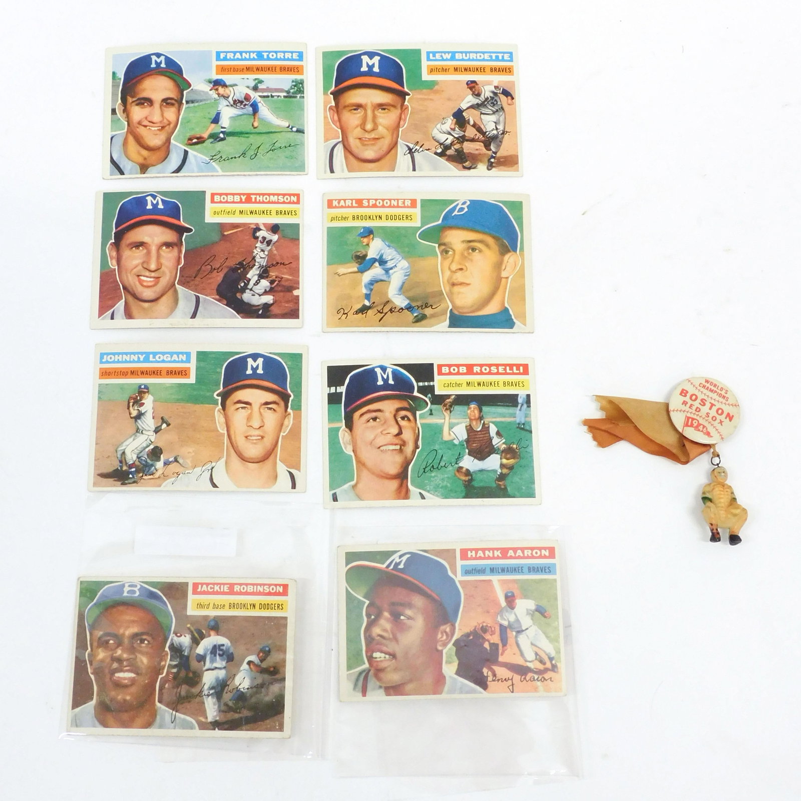 (8) 1950s Baseball Cards Plus Red Sox Pin: To include: Hank Aaron Topps #31; Jackie Robinson Topps #30; Frank Torre Topps #172; Lou Burdette #219; Karl Spooner Topps #83; Bob Roseli Topps #131; Johnny Logan Topps #136; Bobby Thomson Topps #257