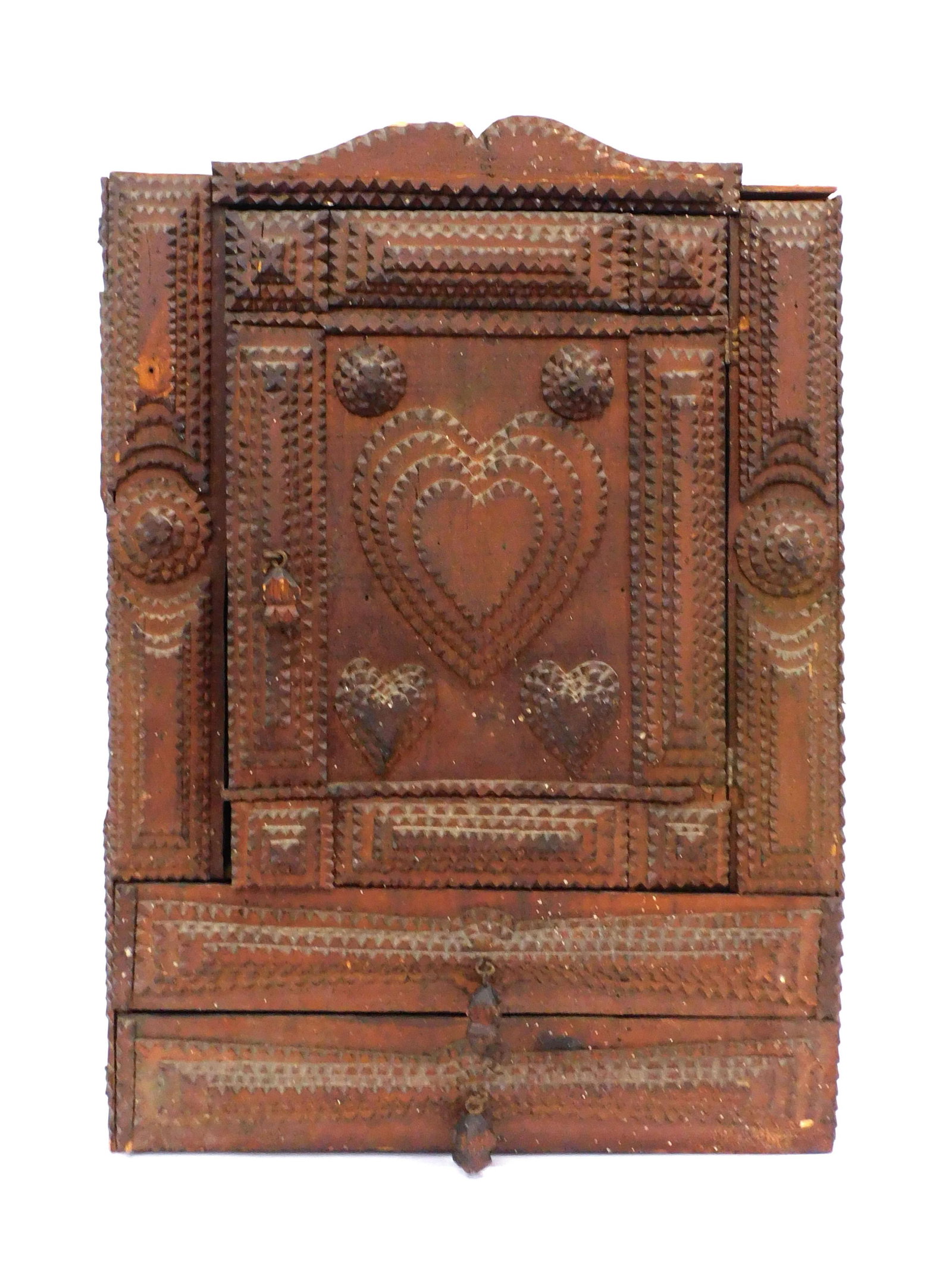A Rare Tramp Art Hanging Cupboard: Late 19th C. With unusual heart motif and two pull out drawers. 26 1/2" high x 19 1/2" wide x 7" deep.