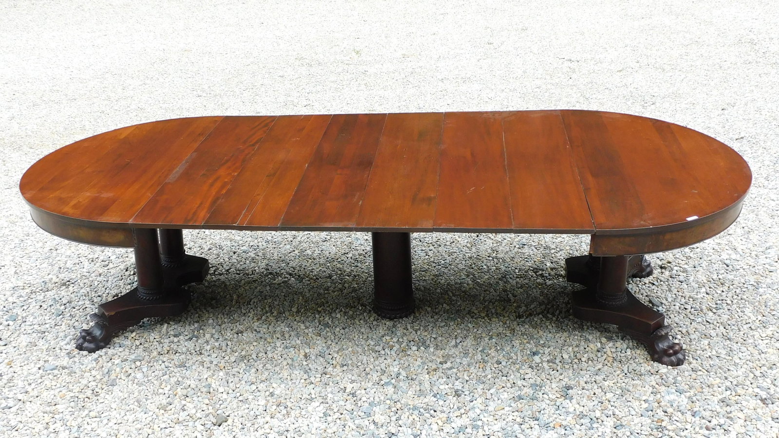 Empire Revival Banquet Table: Late 19th C. Split pedestal. Claw feet. By George Flint, New York. Six original 11" leaves. Round top. 29" high x 54" diameter. Open width 121 1/2" long.