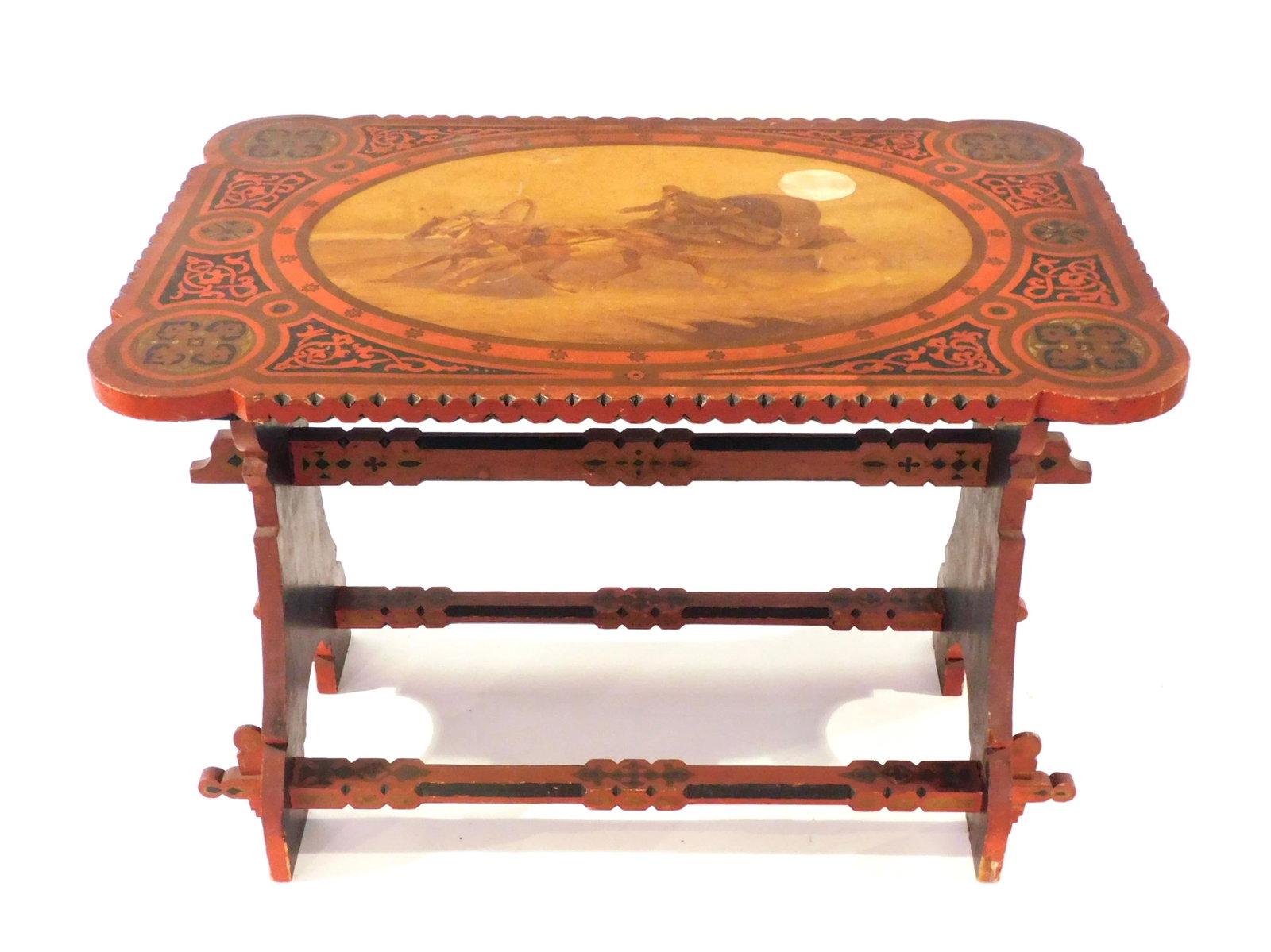 Russian Table: Early 20th C. Hand painted scene with horse drawn cart and passengers under moonlight. Black and red geometric painted design overall. Carved and scalloped top. Pegged mortise and tenon trestle style 