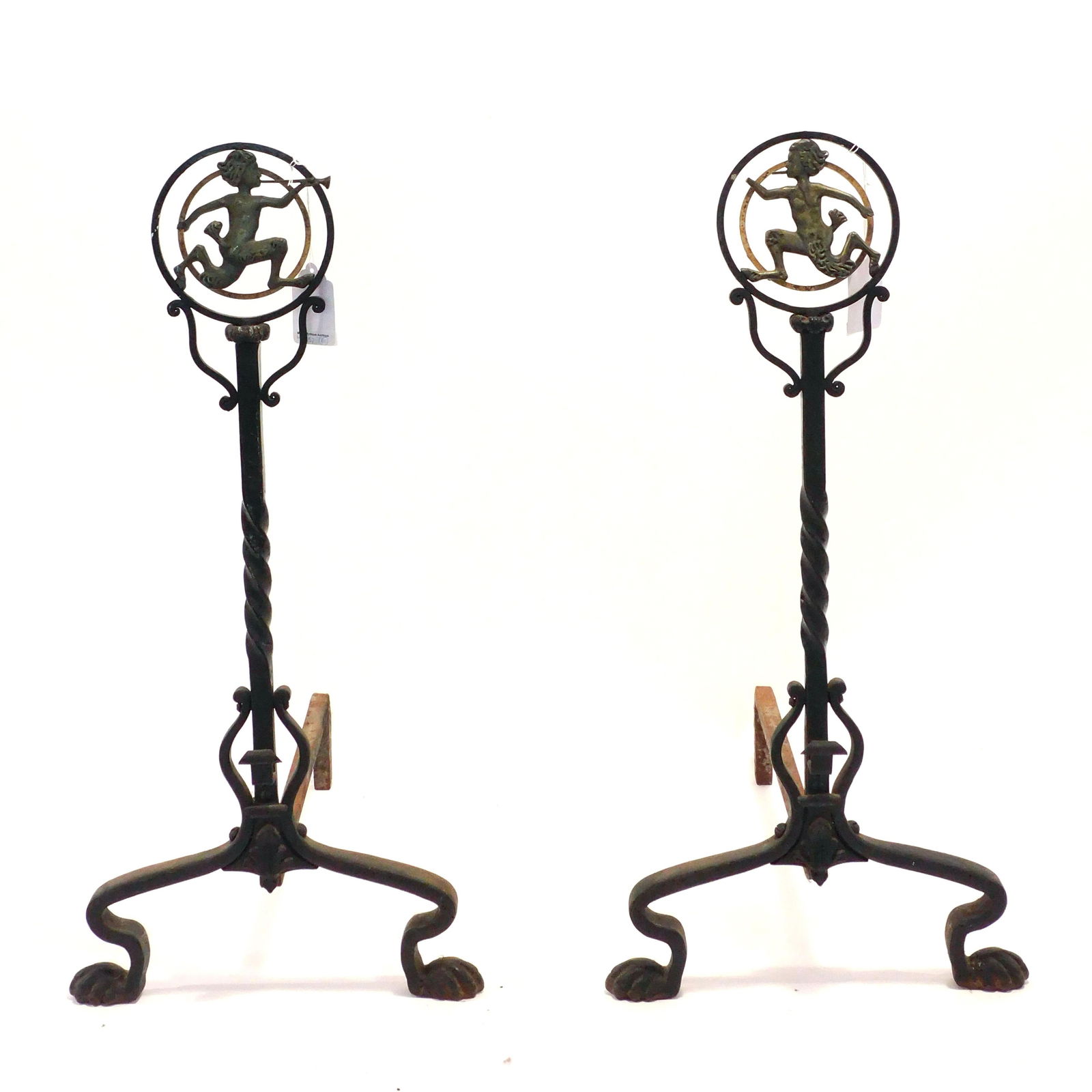 Wrought Iron and Nickel Andirons: Early 20th C. American Renaissance style. Consistent with the designs of Oscar Bach. 30 5/8" tall x 21 1/2" deep x 15" wide. There was a documented console table with the identical figure of Pan as pa