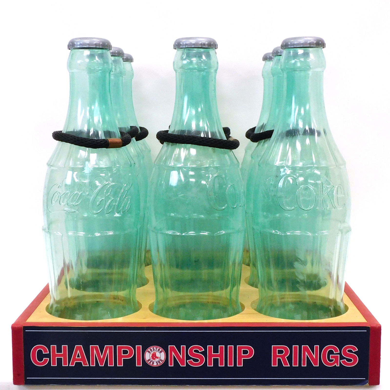Coca-Cola Carnival Ring Toss Game: 21st C. Red Sox Championship rings. Given as a limited-edition premium to commemorate winning the World Series. Includes nine plastic bottles, eight with their rings. Bottles measure: 12" high x 6" di