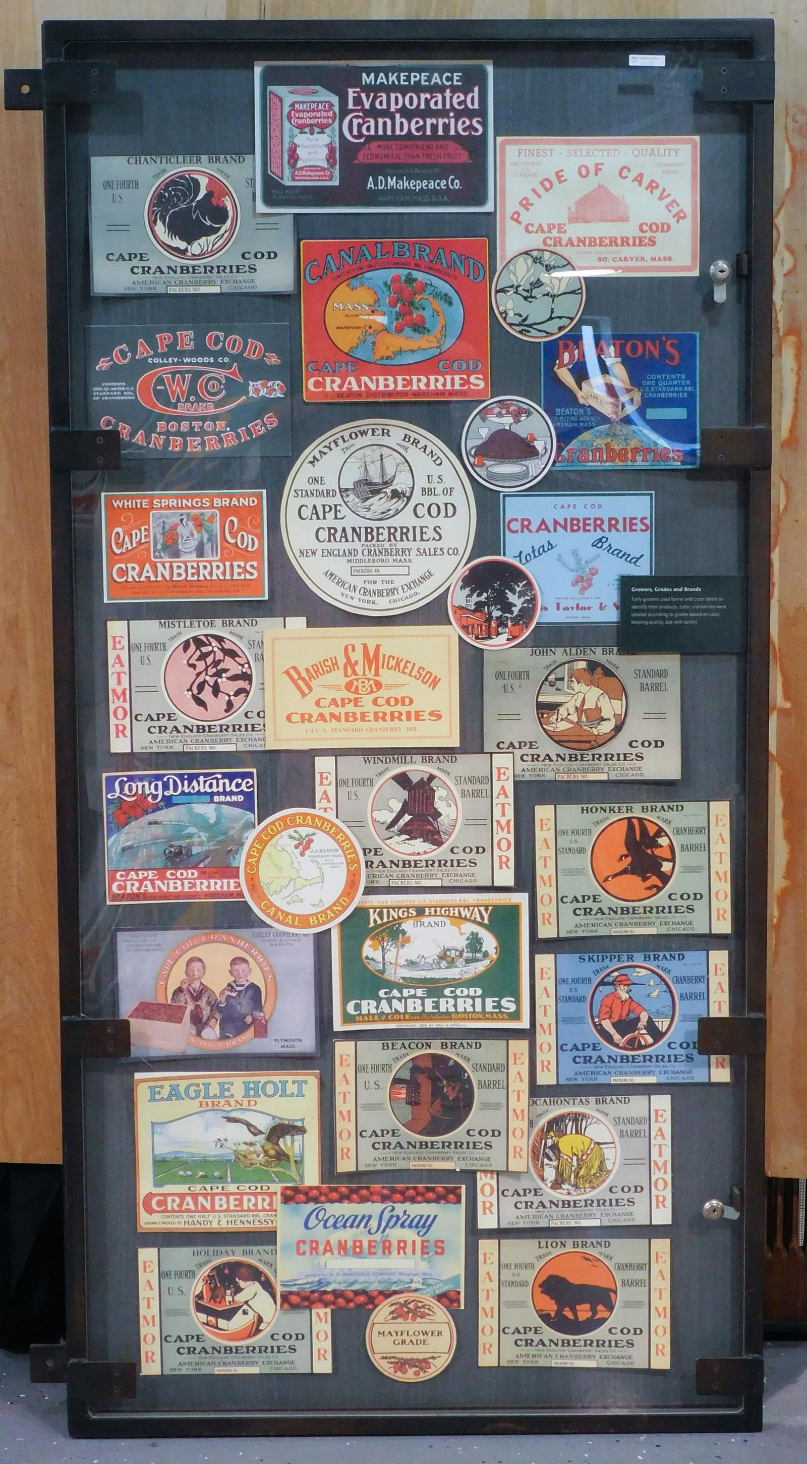 Large Collection of Cranberry Labels: Early to mid-20th C. Housed in heavy iron and Plexiglas case. Approximately (30) labels to include: Makepeace Evaporated Cranberries; Cape Cod Cranberries Mayflower Brand; John Alden Brand; Eagle Holt