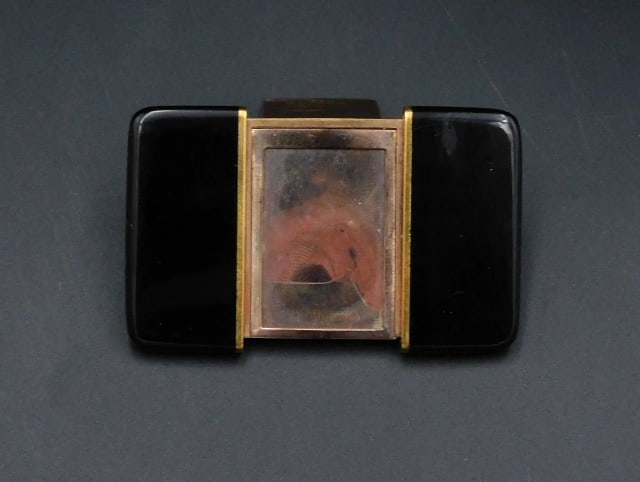 Vintage Art Deco Collapsible Travel Picture Frame: 1930s. St. Dupont, Paris. Black enameled and gold-plated case. 1 3/4" high x 1 3/8" wide closed; 2 3/4" wide when open.