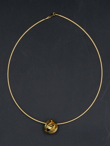 Yellow Gold Choker with Pendant: Possibly by Tiffany & Co. Tests 18kt. Entwining circle design pendant. Choker 5 1/4" diameter. 6.4 total dwt. Please note this lot must be paid for by cash, wire transfer or known check. Items will be
