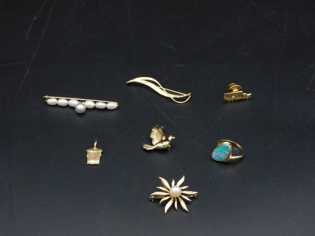 (7) Gold Jewelry Items: 20th C. Tested 14kt. To include: (A) Trash can pendant. 7/8" high. (B) Fiery opal ring. Size 5.75. (C) Sea pearl bar pin. 2" wide. (D) Garbage truck tie tack. 7/8" wide. (E) Floral shaped pin with pea