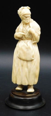 German School Sculpture of a Peasant Woman: 19th C. Caved figure mounted on a round wooden base. Figure measures 6" high; 7" overall.