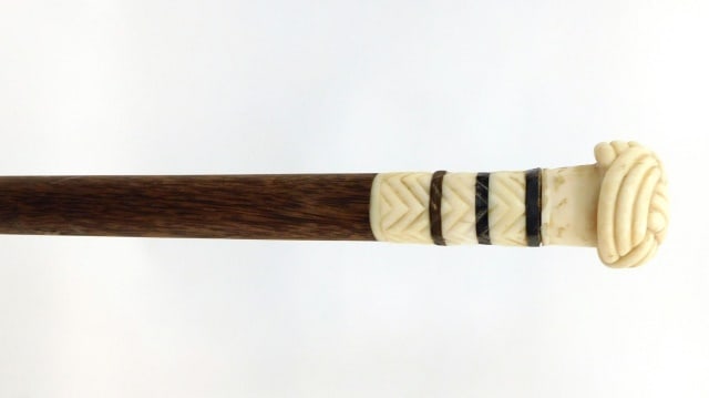 Scrimshaw Walking Stick: 19th C. Carved pommel Turk's head top with baleen inlaid bands and exotic wood shaft with brass tip end. 34 1/2" long.