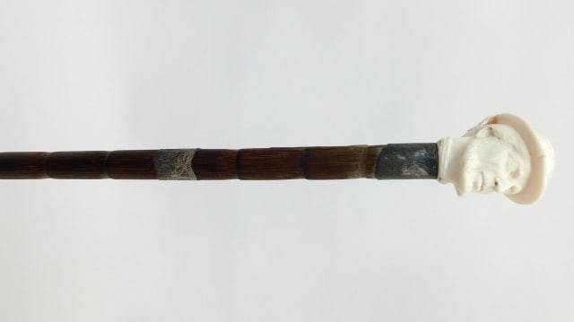 Victorian Walking Stick: 19th C. Exotic wood shaft. Inlaid silver bands. Carved sailor head top. 35" long.