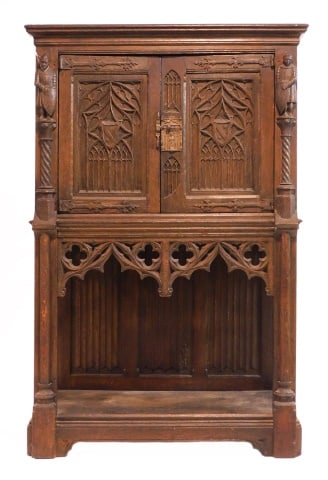 Gothic Revival Cupboard: 19th C. Probably English. Carved oak, with full figured carved knights, linen fold carved sides, gothic arch style doors, frieze and lower shelf. 58" high x 38" wide x 21" deep. Provenance: From the e
