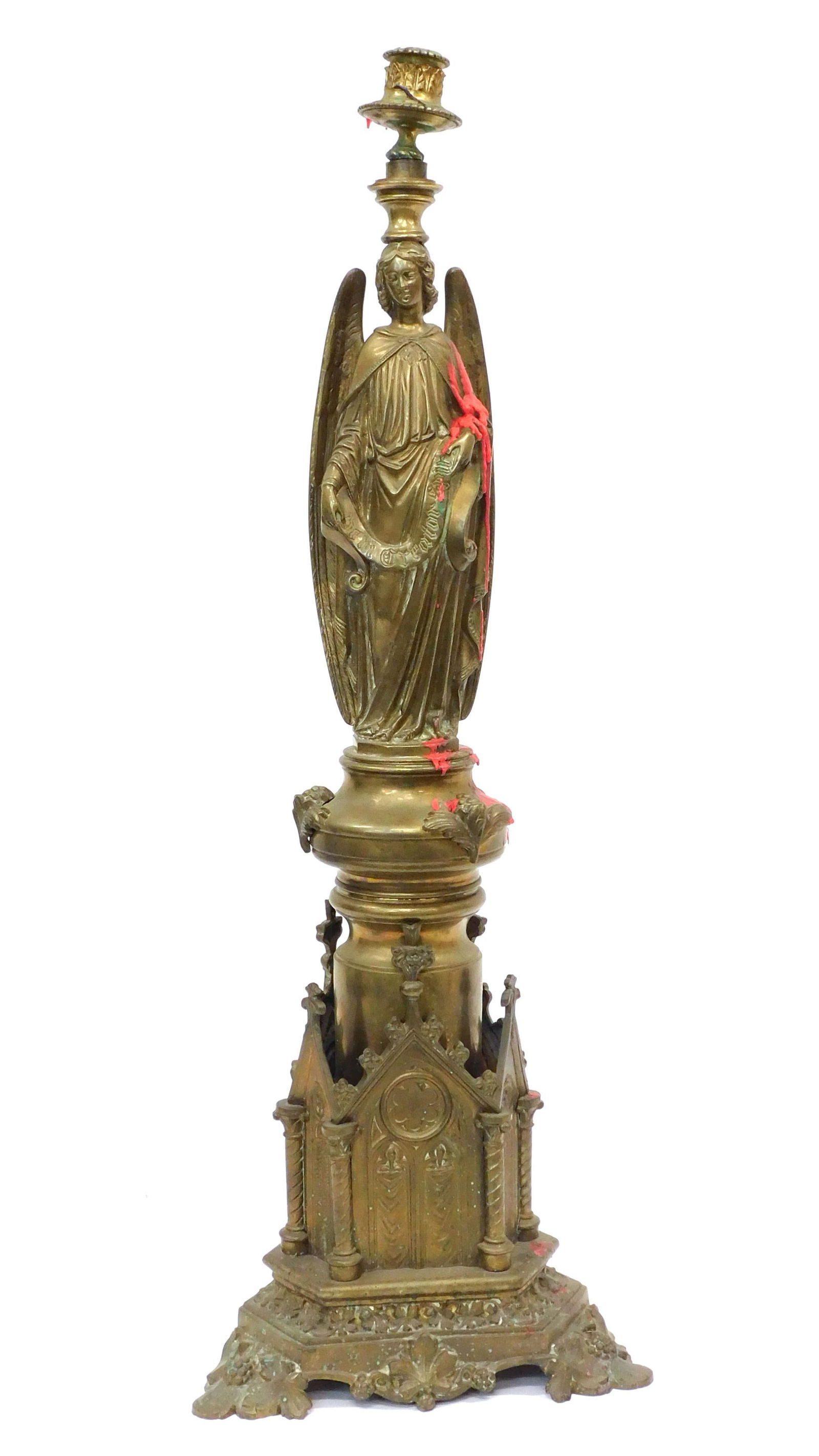 Tall Brass Candlestick: 19th C. Ecclesiastical motif and figural winged angel. 31" high x 10 1/2" wide at base. Provenance: From the estate of Rodney Hilton Brown.
