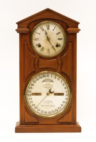 Ithaca Calendar Clock: H.B. Horton's. Patent April 18, 1865 and August 23, 1866. Ithaca, New York. Walnut case. Time and strike. 22 1/2" high x 12" wide x 4 1/2" deep.