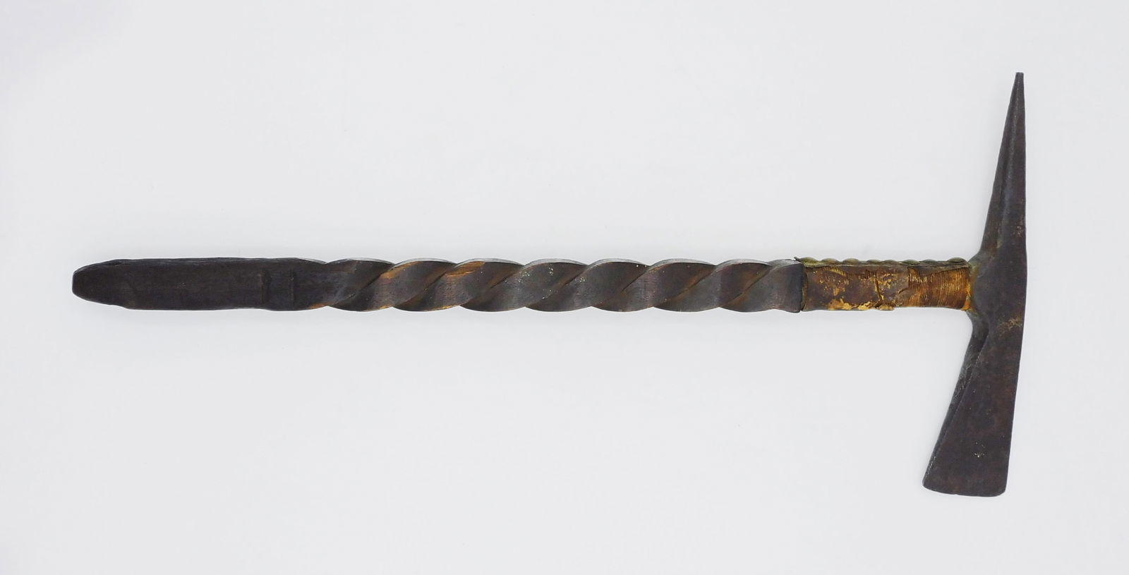 Trade Pickaxe: 19th C. Carved wooden twist handle. Brass tacks and leather. 19" long x 9" wide.