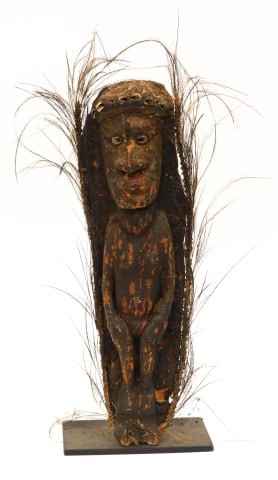 Sepik River, New Guinea Ancestor Figure: Late 19th C. Wooden with original hair and cowrie shell inlay. 15" high x 4" deep. Mounted on a modern metal base measuring: 4" high x 6" wide. Provenance: From the estate of Rodney Hilton Brown.