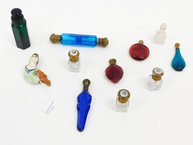 (11) Scent Bottles: 19th C. To include: (A) Olive green glass bottle with paneled sides. 4" high. (B) Aquamarine bottle. Teardrop shape with cut design and brass stopper. 3" high. (C) Cobalt blue cut with faceted sides.