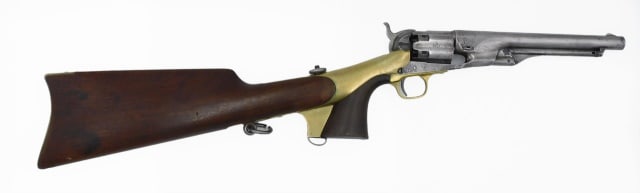 Colt Army Percussion Revolver: Dated 1850. 44 caliber cap and ball percussion revolver with fluted cylinder and detachable shoulder stock with saddle ring. Serial #1592, all matching serial numbers. Stock is serial #1514 with brass