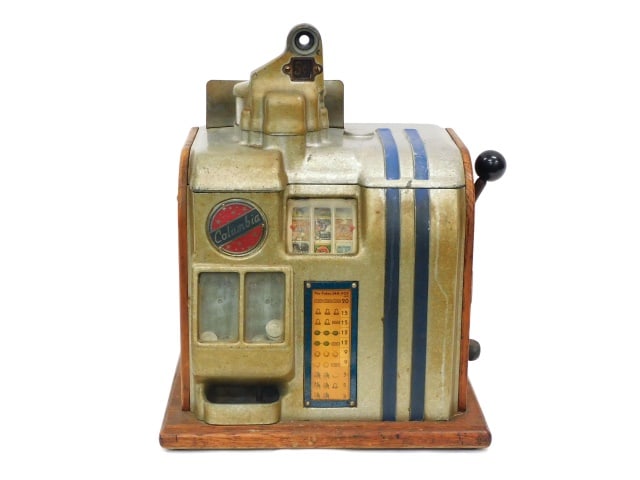 Vintage 5 Cent Columbia Slot Machine: 20th C. Art Deco style. Cast aluminum with an oak base and side. With cigarette logos. 18" high x 14 1/2" wide x 11 1/2" deep.