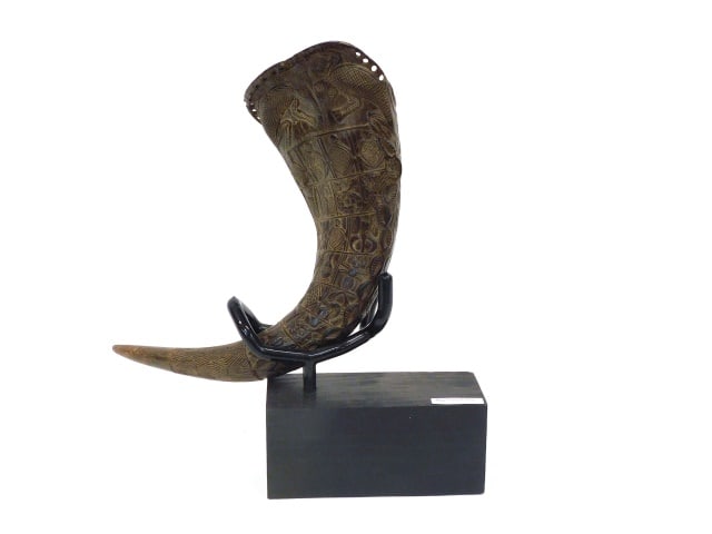 Antique Water Buffalo Horn: Late 19th/Early 20th C. Heavily carved with people and animals. 14" wide x 5" deep. Comes with a customer made stand. Provenance: From the estate of Rodney Hilton Brown.