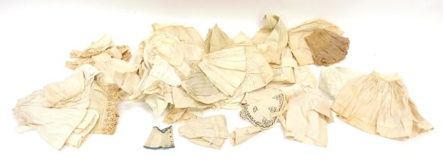 Collection of Doll Undergarments: 19th C. To include a variety of chemises and shifts, petticoats, drawers, blouses and corset covers, nightgowns, and bonnets. (11) nightgowns; (16) shifts and chemises; (13) drawers (some are closed a