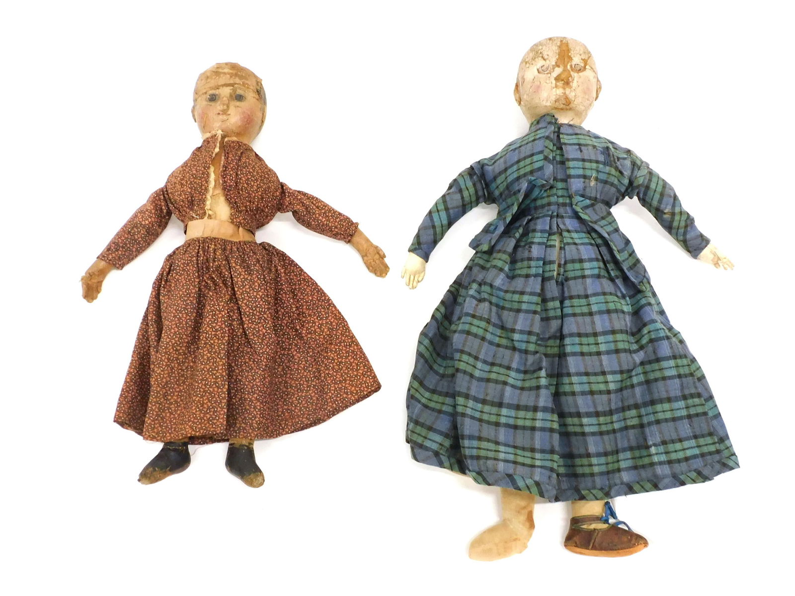 (2) Izannah Walker Dolls: (American/Rhode Island, 1817-1888). Folk art cloth painted face dolls. The larger doll is 19” long and is wearing a blue and green tartan dress with a matching jacket, corset cover, two petticoa