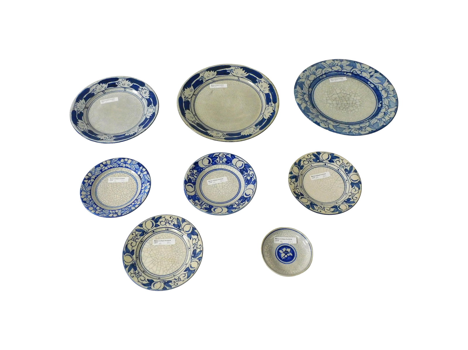 (8) Pieces Dedham Pottery: Early 20th C. To include: (A) Pond lilies: Two plates. 8 1/2" and 9 7/8" diameter. (B) Magnolias. Plate. 10" diameter. (C) Horse chestnuts. (3) plates. 6-6 1/4" diameter; (D) Azaleas. Plate. 6" diamet