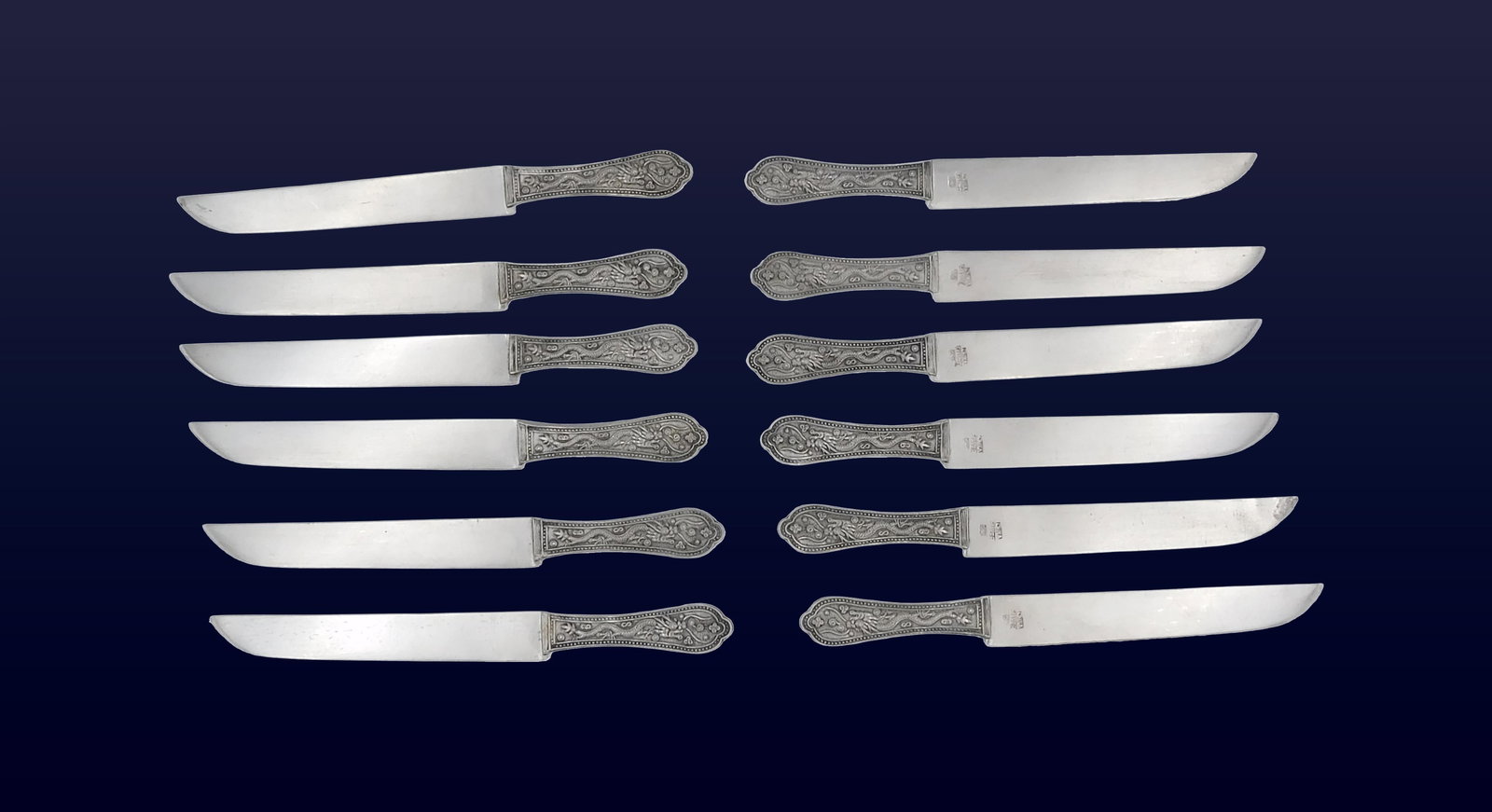 (12) Asian Silver Knives: 19th C. Dragon handles. 5" long. 4.3 total ozt. Stamped China silver.Good condition. Please note this lot must be paid for by cash, wire transfer or known check. Items will be shipped or sent to shipp