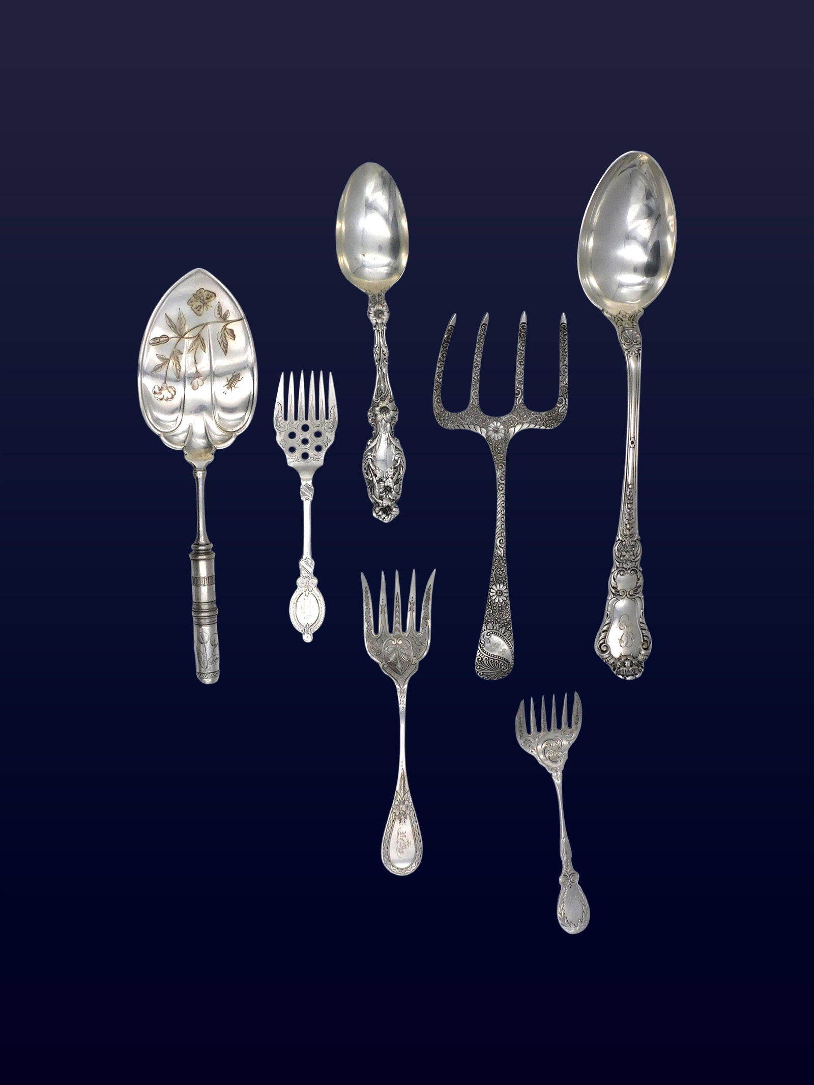 (7) Coin and Sterling Silver Serving Pieces: 19th/20th C. To include: (A) Serving spoon. Whiting. Lily pattern. 8 1/8" long. (B) Asparagus or bread fork. Davis & Galt. Medallion pattern. 8 3/4" long. (C) Coin silver serving fork. 6 1/4" long. (D
