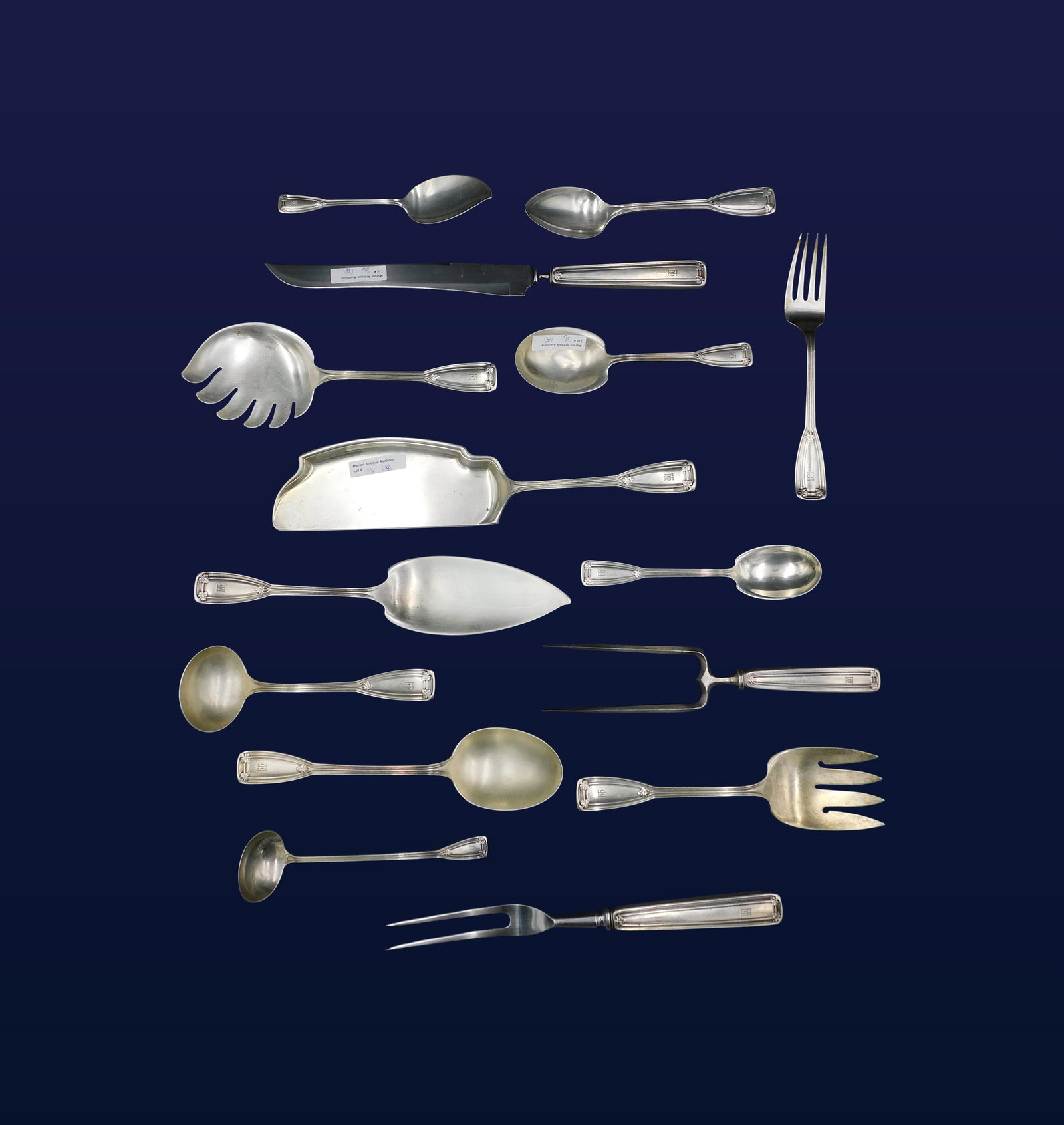 (15) Tiffany & Co. Sterling Silver Serving Pieces: Early 20th C. Saint Dunstan pattern. To include: (A) Large serving spoon. 9 1/2" long. (B) Serving spoon. 7 1/2" long. (C) Ladle. 7 1/4" long. (D) Fish fork. 8 3/4" long. (E) Macaroni Server. 9 1/2" l