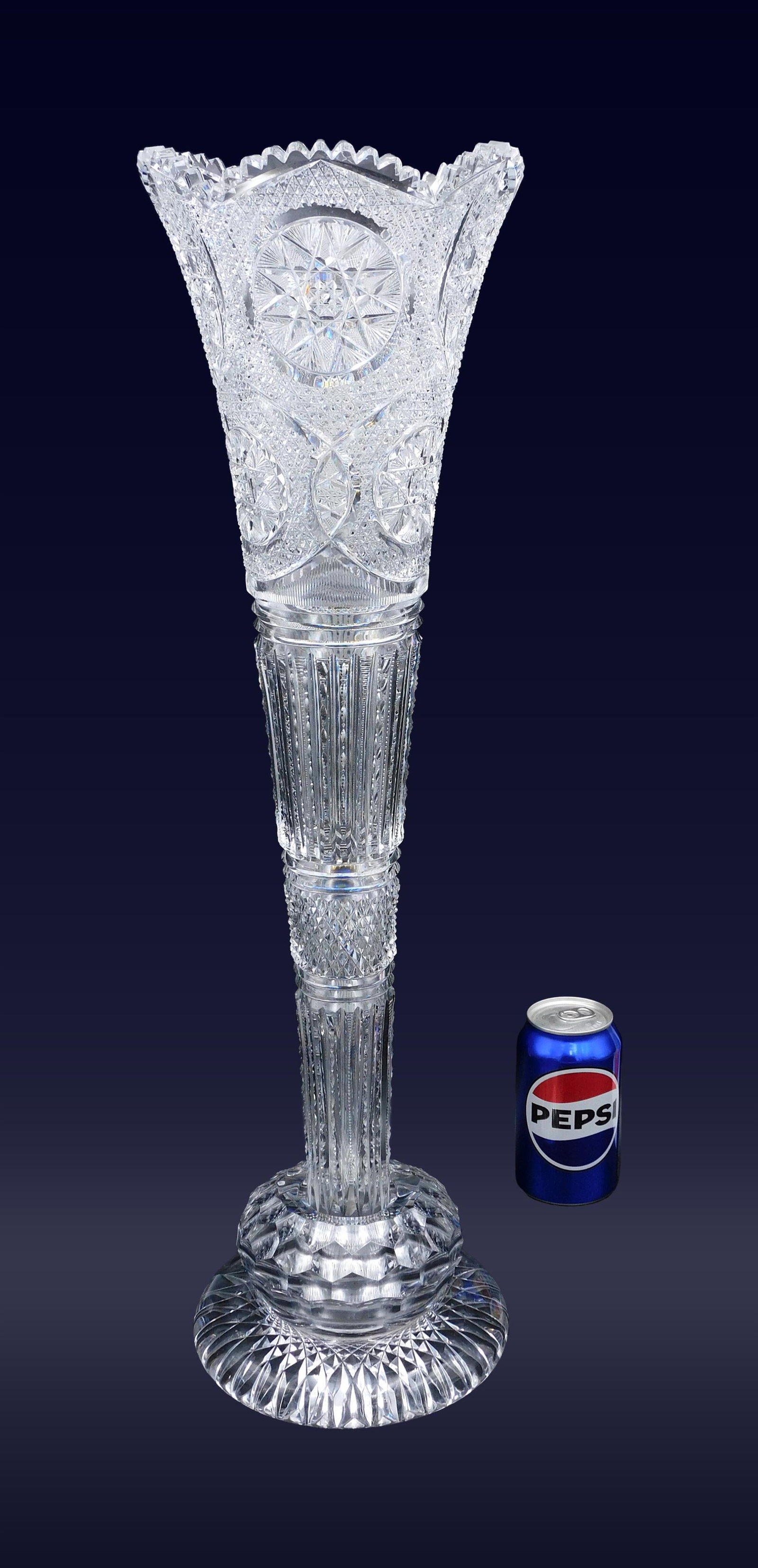Monumental Brilliant Period Cut Glass Trumpet Vase: Late 19th C. American. In two parts. Hobstar design. In a round faceted footed base. Overall height: 25" x 7" wide at top. 14.2 lbs. Appears to be in good to excellent condition. One small nick to