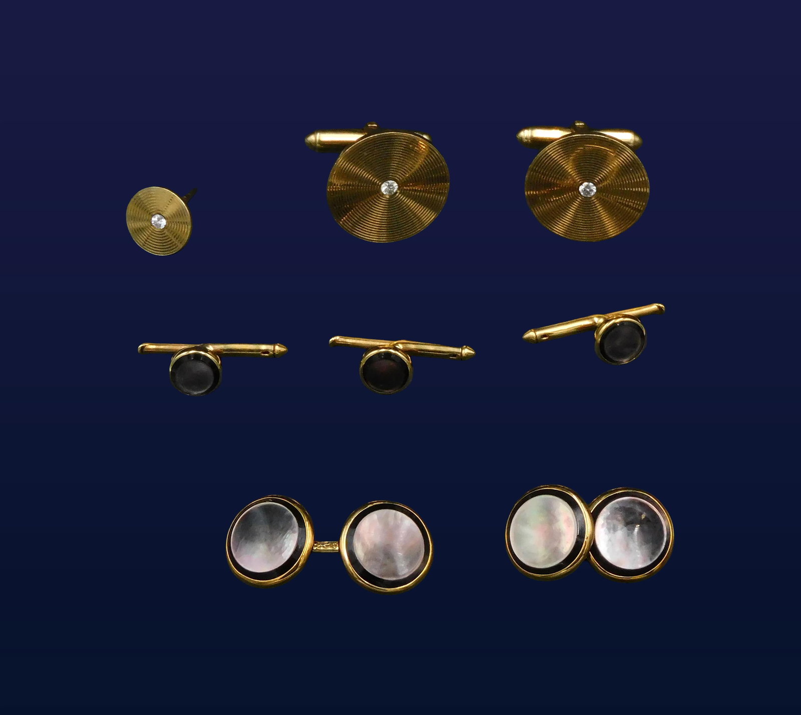 (2) Sets of Cufflinks: To include: (A) 10kt set consisting of cufflinks and three shirt studs. Set with purplish mother of pearl. 5.8 dwt. (B) 14kt cufflinks and tie tack set with small diamonds. 8.8 dwt. Please note this l