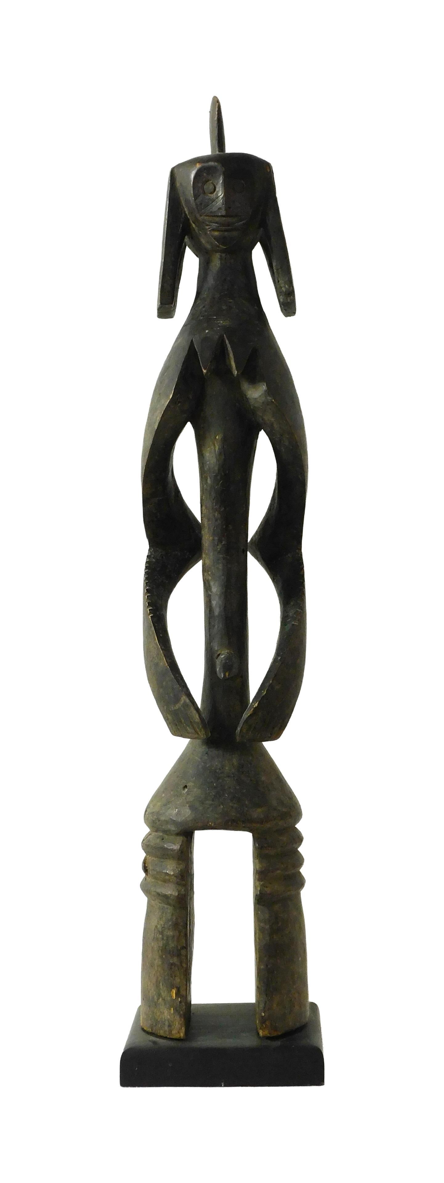 Nigerian Mumuye Sculpture: 20th C. Male carved figure. Iagalagana carved wood. Mounted on a wood base. Sight size: 38 1/2" high x 7" wide x 8" deep. Overall height with base: 40" high.Sculpture shows chipping and wood loss