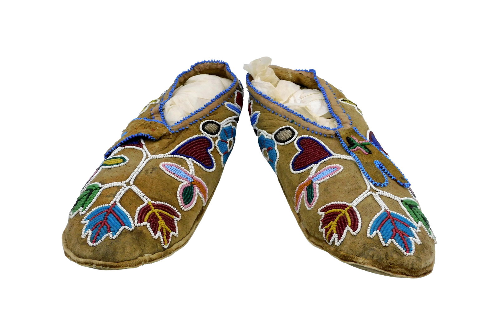 Pair of Beaded Moccasins: 19th C. Northern Woodlands. Leather and beadwork of leaves and hearts. 10" long.Shows wear consistent with age and use. IMPORTANT- Please note: all items are sold as is, where is, with all faults. Mar