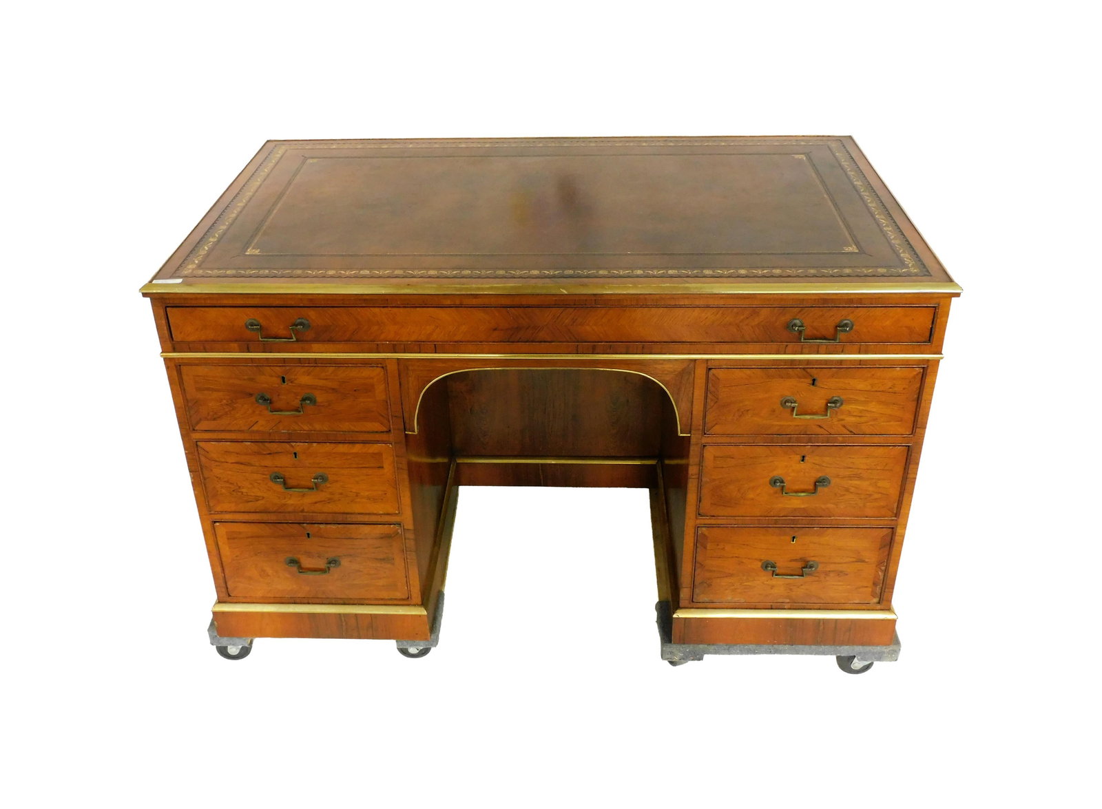 English Mahogany Desk: Late 19th C. Mahogany and mahogany veneer. Rectangular embossed tool leather top. Pull out writing surface. Double bank with three graduated drawers on one side. False drawers on rear. 31" high x 50 1