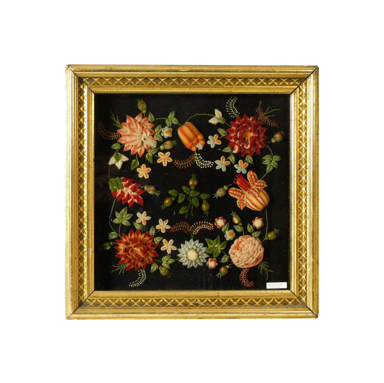 Stumpwork Picture: 19th C. Floral design. Sight size: 17" high x 17" wide. In a period gilded shadowbox frame under glass measuring: 22" high x 22" wide.Good condition. Frame shows slight losses. Not removed from
