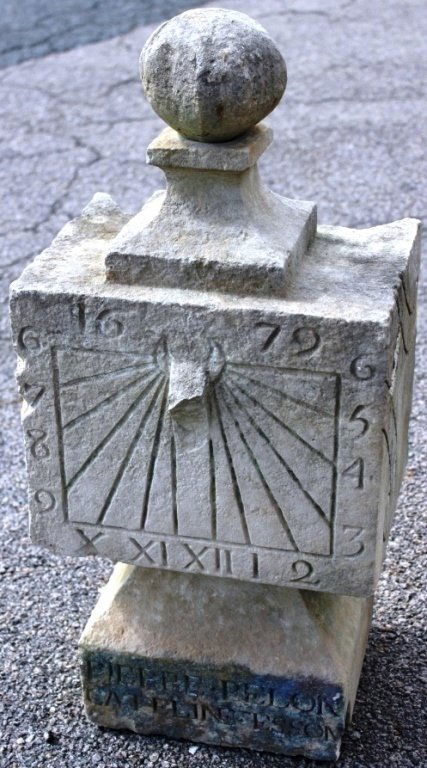 LATE 17TH C CARVED SANDSTONE SUNDIAL: DATED 1679; SHOWS SOME DAMAGE; MISSING ELEMENTS; 28" HIGH; 12 3/4" WIDE; 9 1/2" DEEP; CARVED INSCRIPTION READS PIERRE PELO CAELINE ESSON.
