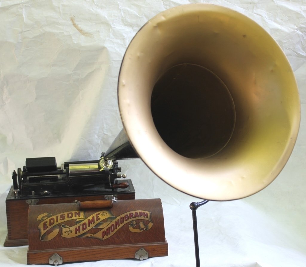 EDISON HOME PHONOGRAPH WITH BRASS AND TIN: HORN; OAK CASE WITH ORIGINAL STENCIL DESIGN; WORKING CONDITION; COMPLETE WITH RECORDER; H23458; 11" HIGH; 16 1/2" WIDE; 8" DEEP; 30 1/2" HORN WITH CRANE AND BASE.