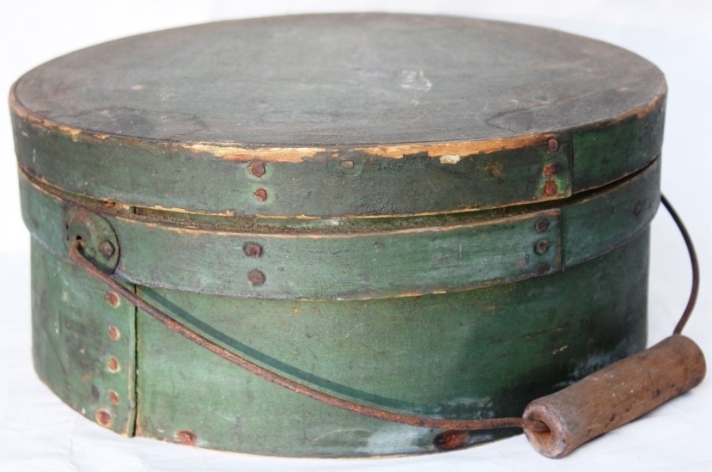 19TH COVERED PANTRY BUCKET; ORIGINAL GREEN: PAINTED FINISH; IRON BAIL HANDLE; SHOWS SOME SEPARATION TO BANDING; 7" HIGH; 11 1/2" DIAMETER.