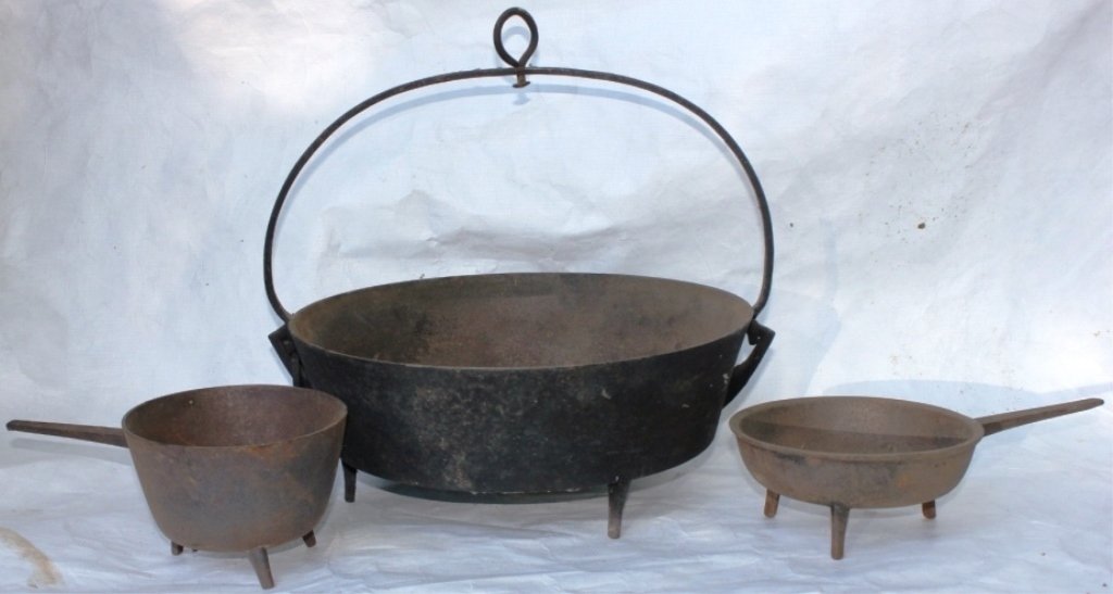 THREE PIECE LOT OF EARLY 19TH C CAST IRON COOKWARE: INCLUDING TWO HANDLED POTS AND LARGE ROUND COOK POT WITH WROUGHT IRON HANDLE.