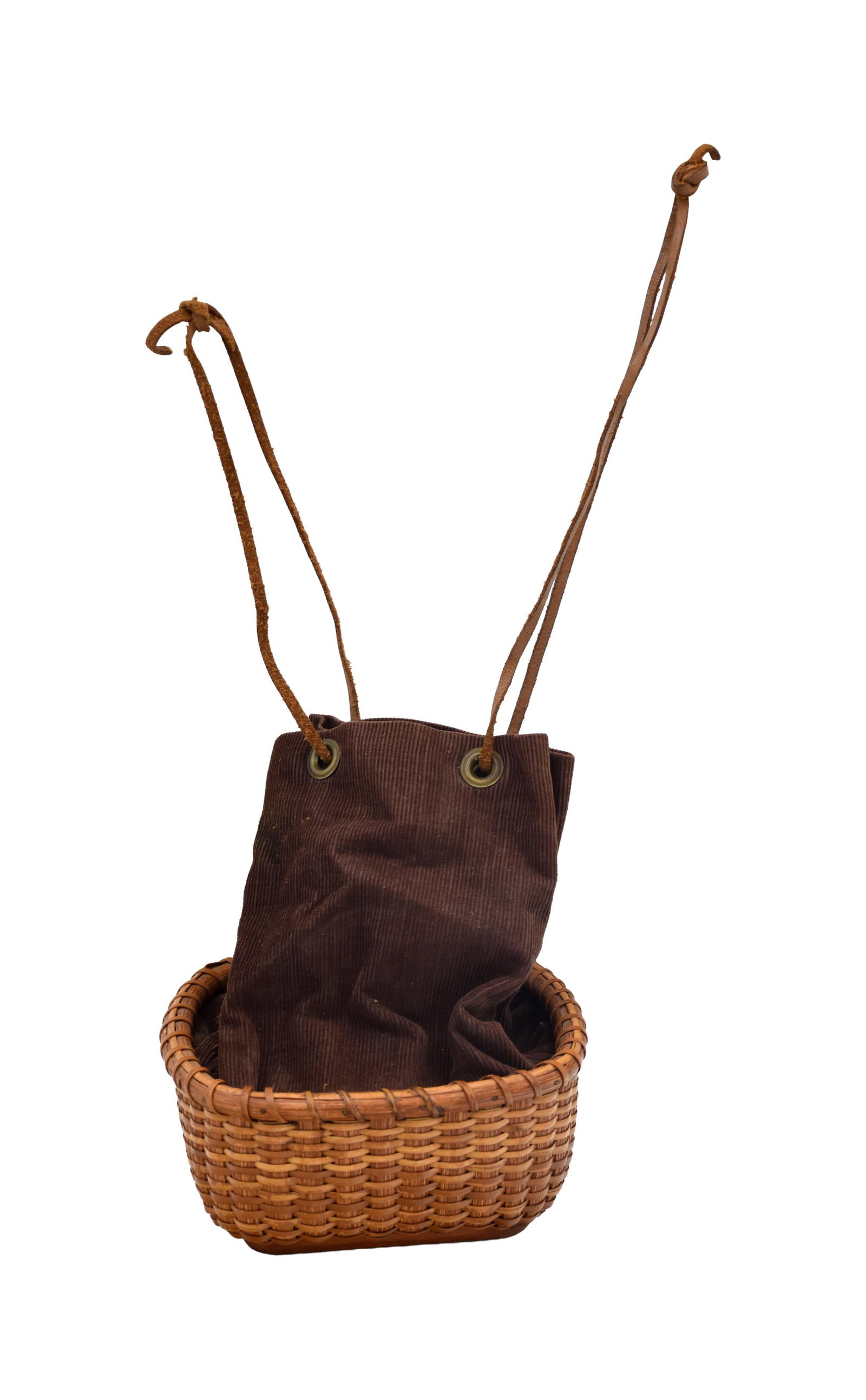 Jose Formoso Reyes Nantucket Drawstring Purse: (Philippines/American, 1902-1980). Brown corduroy liner. Leather drawstring. Brass grommets. Stamped on bottom: "Made in Nantucket, Jose Formoso Reyes". 3" high x 6 1/2" square.Good original