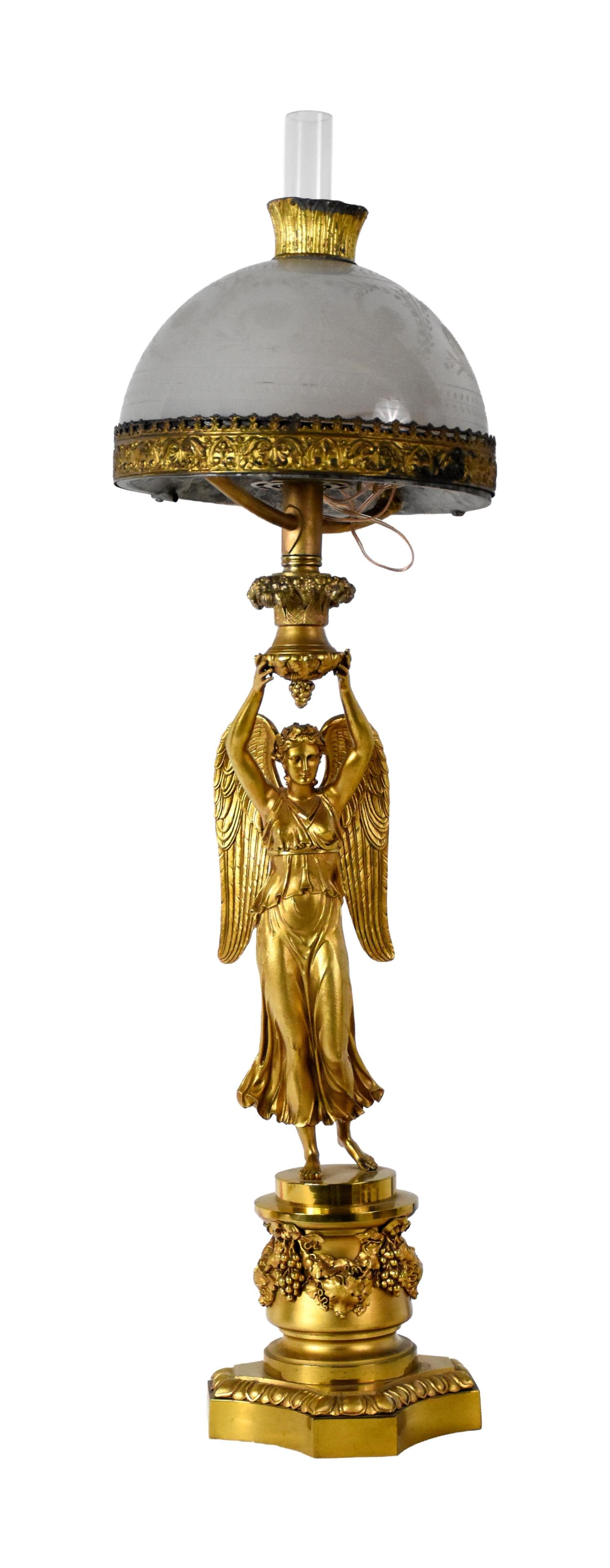 Gilt Bronze and Brass Figural Astral Lamp: 19th C. Full bodied angel mounted on a classical plinth. Period frosted and engraved glass shade. Overall height with chimney: 38 1/2". Shade is 10" diameter. 26.2 lbs. Provenance: Estate of Alfred