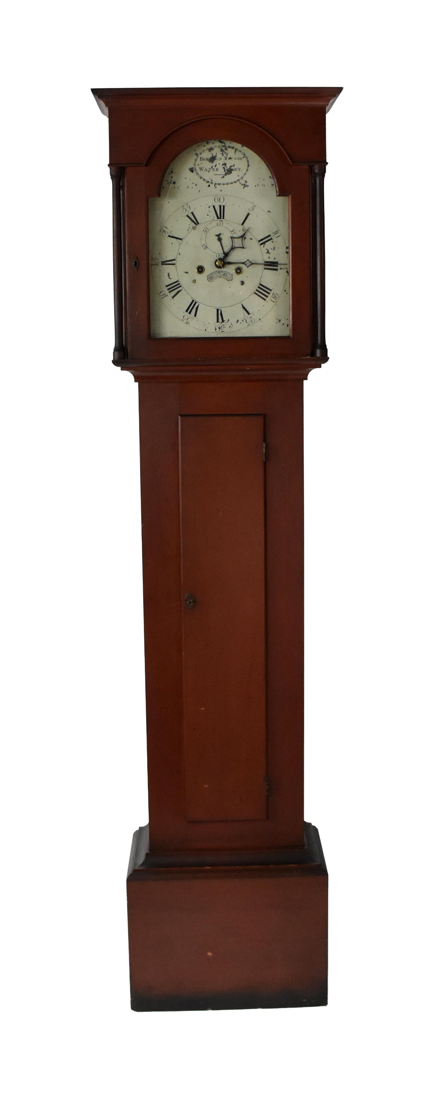 Rare Shaker Tall Case Clock, Benjamin Youngs Sr.: Ca. 1808. Watervliet, New York. Original bittersweet red painted surface. Brass works with double bell. Painted iron tombstone shape dial. Signed on front and on back. Initialed "B.Y. Fecit, 1809"
