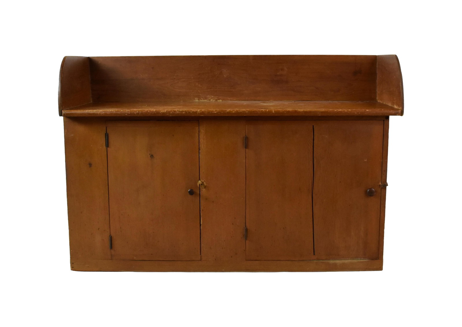 Shaker Bucket Counter: 19th C. Pine. High backsplash with arched fronts. One board top base with two doors. Bread board ends. Turned peg knobs. One door: 21 1/4" high x 13 1/2" wide. The other door: 21 1/4" high x 20 1/2"