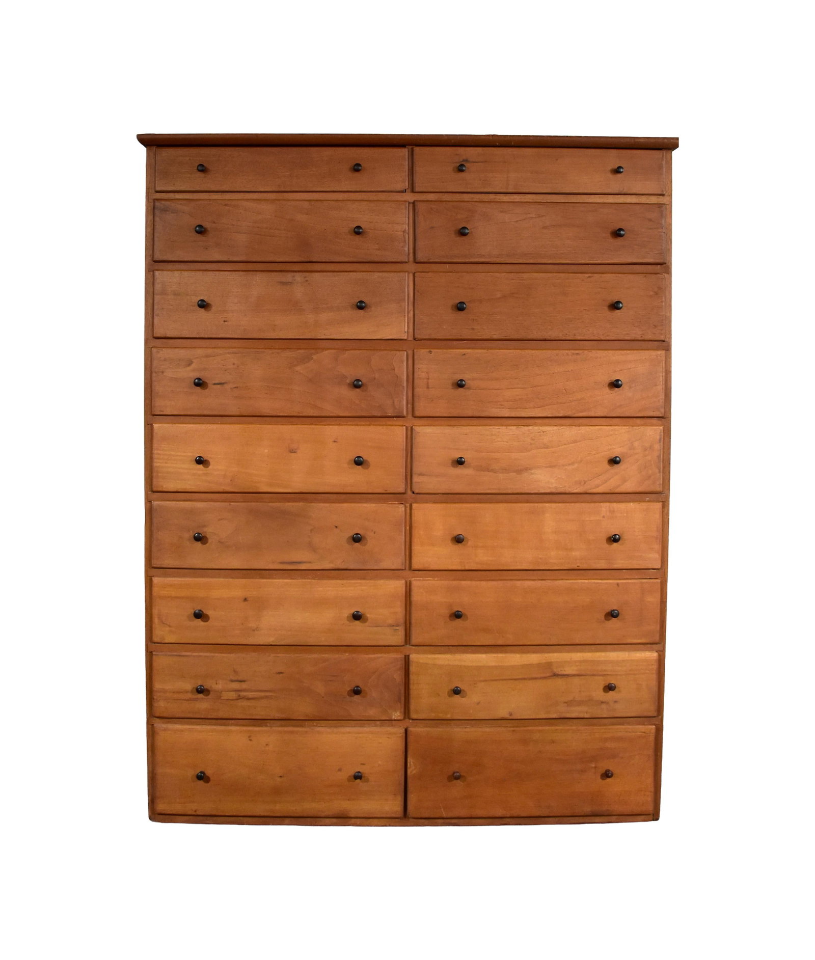 Shaker Eighteen-Drawer Tall Chest: Early 19th C. Probably Hancock, Massachusetts. Butternut. Two sets of nine graduated drawers with tapered sides, each having a pair of turned black cherry pegged in knobs. Quarter round molded top.