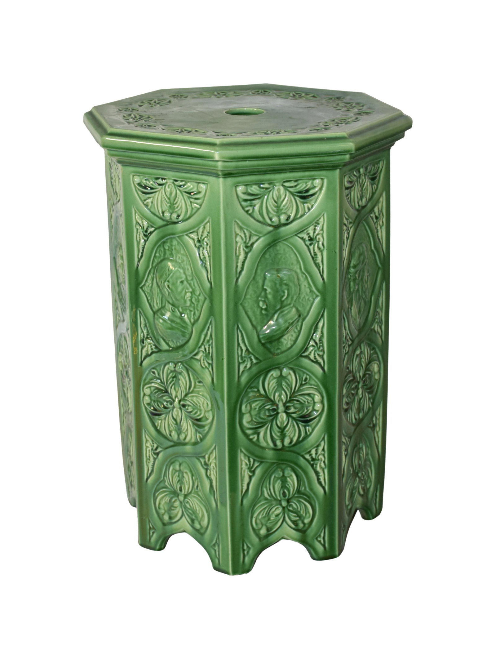 Arts & Crafts Pottery Plant Stand: Early 20th C. Possibly Minton. Octagonal top. Sides depict various male images and medallion design. Drainage hole on top. 20" high x 15" square. Approx. 27 lbs. Good condition. IMPORTANT- Please