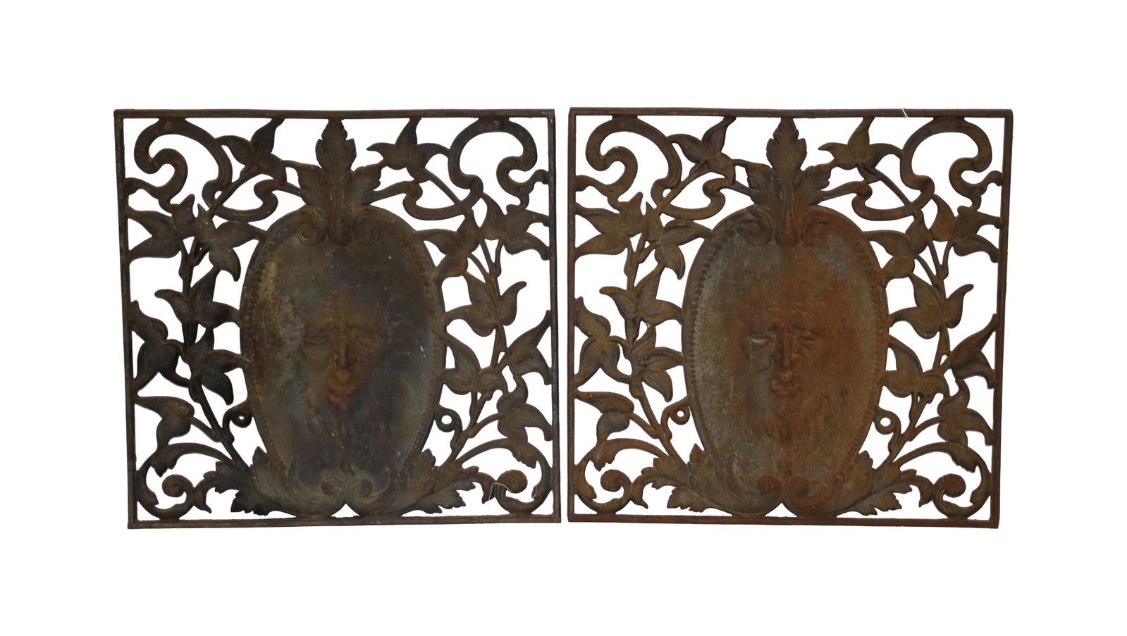 Pair of Decorative Victorian Cast Iron Grates: Late 19th/Early 20th C. Central panel depicts a mythological head of a man with ornate floral border. 22" square. Approx. 29 lbs. each. Provenance: Estate of Alfred J. Walker, legendary art dealer