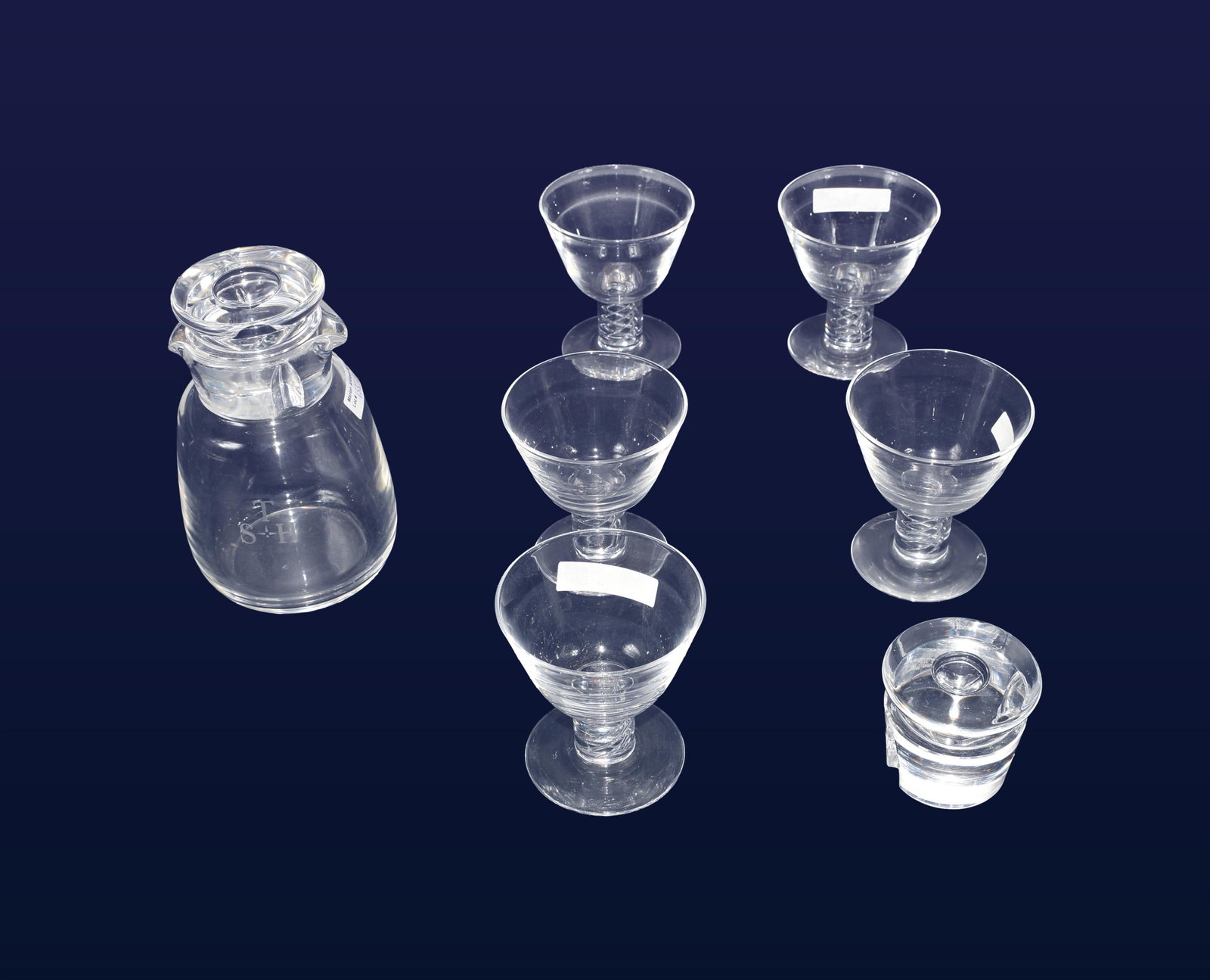 Steuben Glass Decanter and (5) Glasses: 20th C. Air twist pattern. All signed Steuben. Five glasses. 3 3/4" high x 3 1/4" diameter. Along with one double spout decanter with two air trap formed stoppers. 6 1/4" high with stopper x 3 1/2"