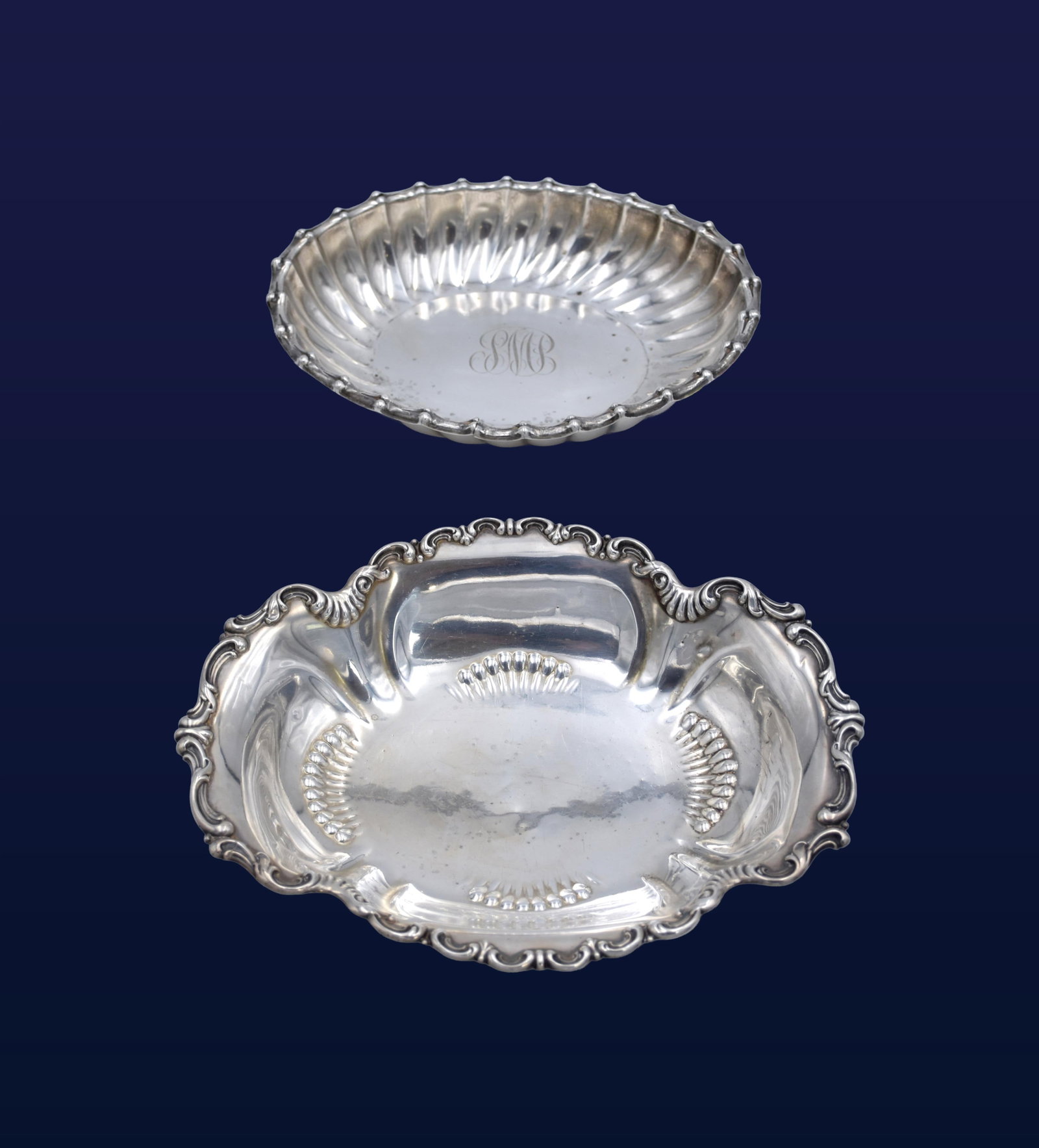 Two Sterling Silver Serving Dishes: 20th C. To include: (A) Gorham. Possibly Chantilly pattern. Foliate rim. 2" high x 11" wide x 8 3/4" deep. 13.86 ozt. (B) Watson Company. 1 3/4" high x 9 3/4" wide x 7 3/4" deep. 11.12 ozt.Good