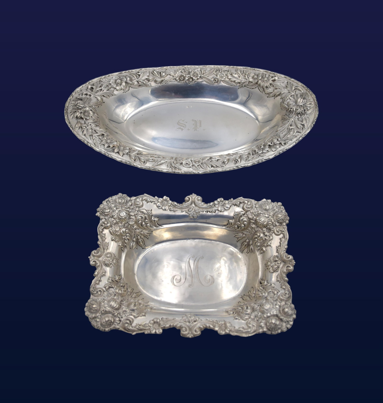 (2) Sterling Silver Repousse Trays: To include: (A) Rectangular tray with ornate border. 1 1/2" high x 8 3/4" wide x 6 1/2" deep. 5.51 ozt. (B) Oval tray with ornate floral border. S. Kirk & Son. 1 3/4" high x 12 1/2" wide x 7 1/2"