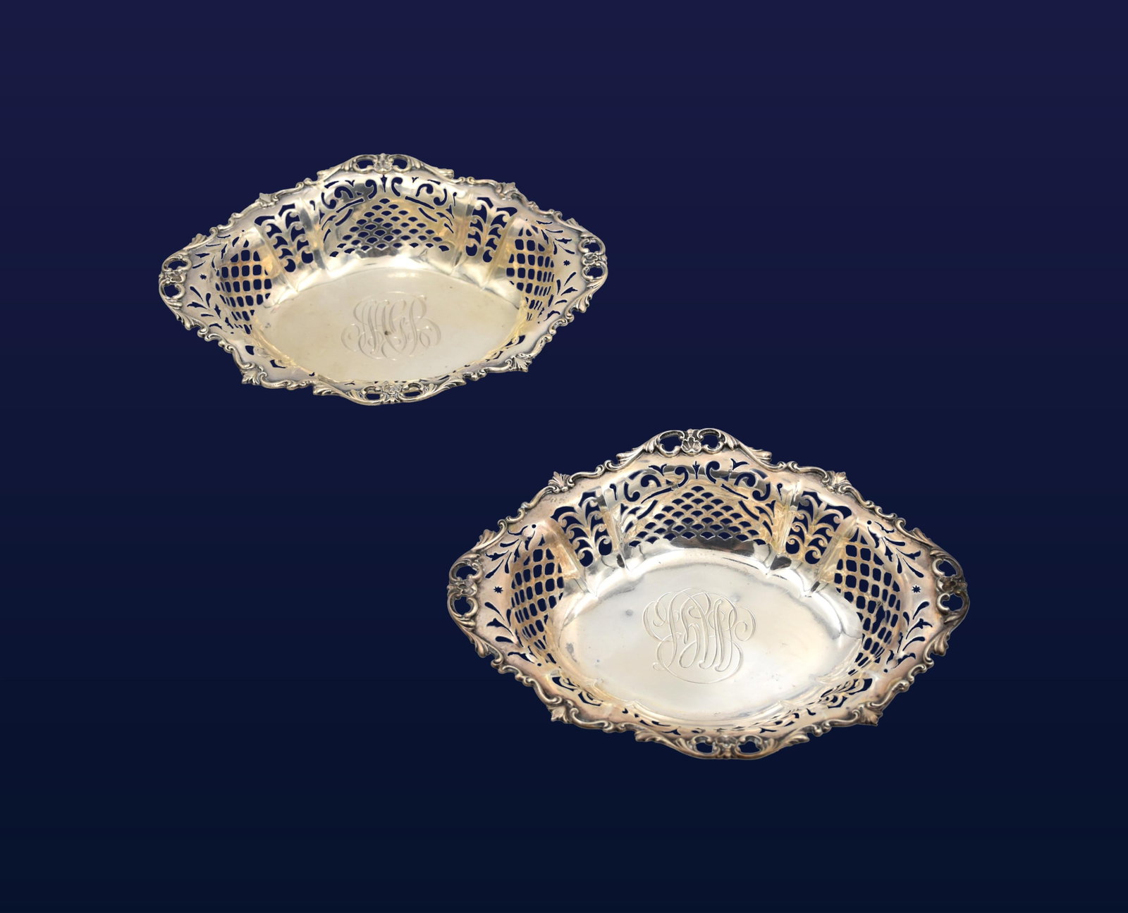 (2) Matching Sterling Silver Trays: Early 20th C. Gorham. Ornate floral details and intricate pierced design. 1 3/4" high x 8 1/2" wide x 6 1/2" deep. 9.54 total ozt. Age appropriate wear. IMPORTANT- Please note: all items are sold as