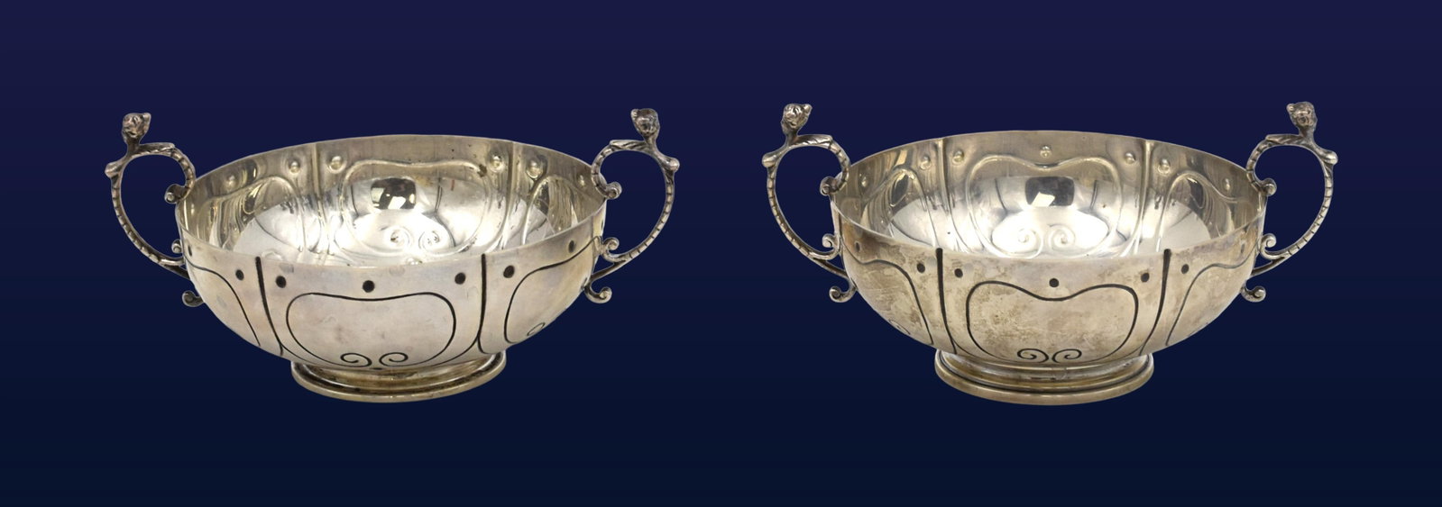 Pair of Sterling Silver Handled Bowls: Mid-20th C. By Ensko, New York after Simeon Soumain. Marked on bottom "Reproduction Circa 1720". One additionally marked Cartier, likely retailed by Cartier. Paneled bodies, punched roundel